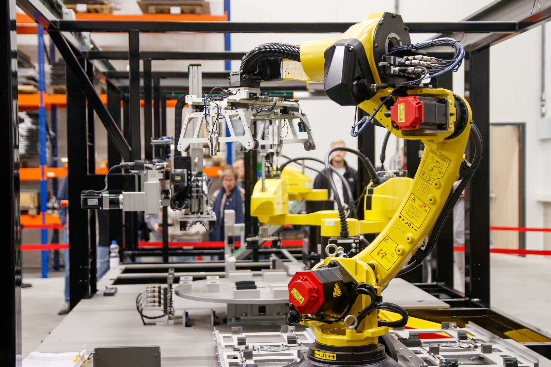 Industrial robotic arm with a gripper working on a manufacturing line